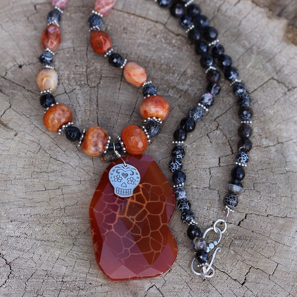 http://dktjewelry.com/cdn/shop/products/Red_crab_agate_stone_pendant_necklace_with_sugar_skull_and_red_and_black_agate_beads_grande.jpg?v=1571269274