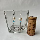 Snowflake earrings with Swarovski pearls and crystals. Cork shown for size reference.