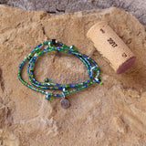 Stretch necklace or triple wrap bracelet with a mix of green and blue seed beads and a sterling tiny heart charm. Cork shown for size reference.