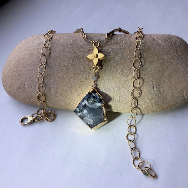 Gold rimmed druzy stone pendant with brass flower and branches on gold filled chain