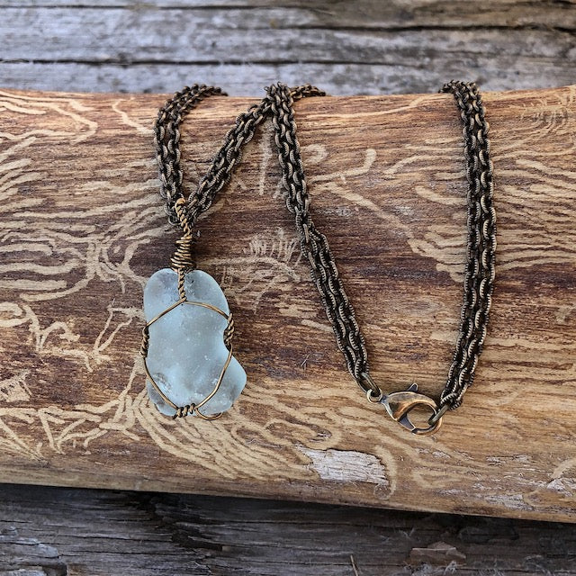 Bronze wire-wrapped sea glass pendant on bronze double chain