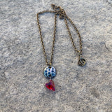 Enamel pendant necklace with a crystal heart