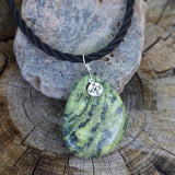 Green agate stone pendant necklace with silver compass charm on twisted rubber cord