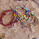 Equality charm stretch necklaces or triple wrap bracelets in red, rainbow, or silver lined rainbow beads