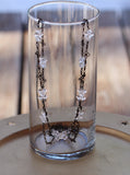 Long flower chain necklace with clear double point crystal clusters.