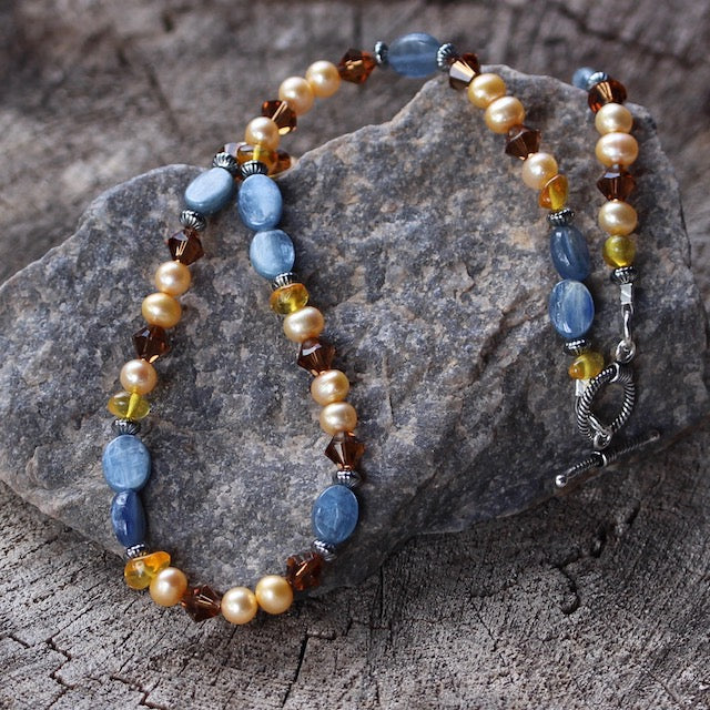 Necklace with kyanite ovals, golden freshwater pearls, mocha Swarovski crystals and amber with sterling silver toggle clasp