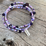 Stretch necklace or triple wrap bracelet with sterling believe charm and purple bead mix.