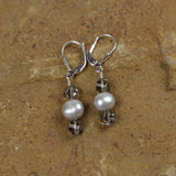 Earrings with silvery freshwater pearls and gray Swarovski crystals on sterling silver ear wires.
