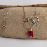 Sterling silver chain necklace with interlocking circles and red Swarovski heart pendant