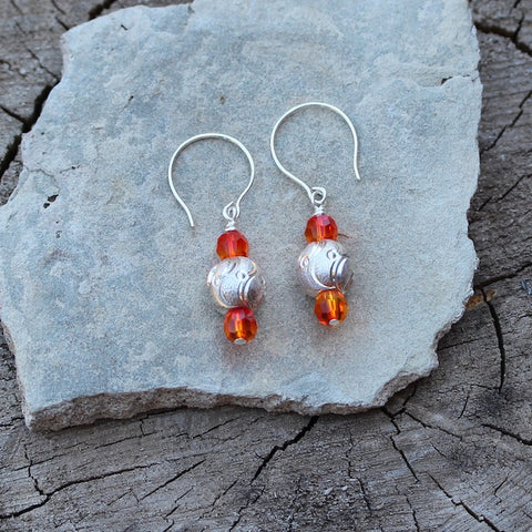 Sterling laser-etched bead earrings with orange Swarovski crystals