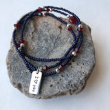 Stretch necklace or triple wrap bracelet with navy blue seed beads, garnet red Swarovski crystals and  sterling charm that reads "I heart you"