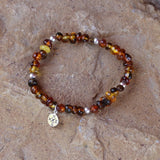 Amber nuggets stretch bracelet with sterling silver compass charm.