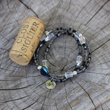 Bike charm stretch necklace or triple wrap bracelet with gray and purple beads and clear crystal accents.  Cork for size reference