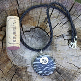 Black silk agate stone pendant necklace with sterling Om charm on twisted rubber cord with cork for size reference