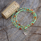 Stretch necklace or triple wrap bracelet with bronze sugar skull and pastel green bead mix