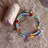 Stretch necklace or triple wrap bracelet with sterling equality charm and rainbow bead mix.  Cork for size reference.