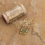 Green and gold crystal earrings with gold-filled ear wires and cork for size reference