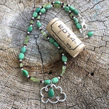"Pray for rain" cloud pendant necklace with faceted turquoise drop and peridot. Cork for size reference