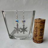 Snowflake charm earrings with Swarovski crystal cubes. Cork shown for size reference.