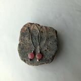 Earrings with silver plated long oval ear wires and pink rhodochrosite and gunmetal brass beads.